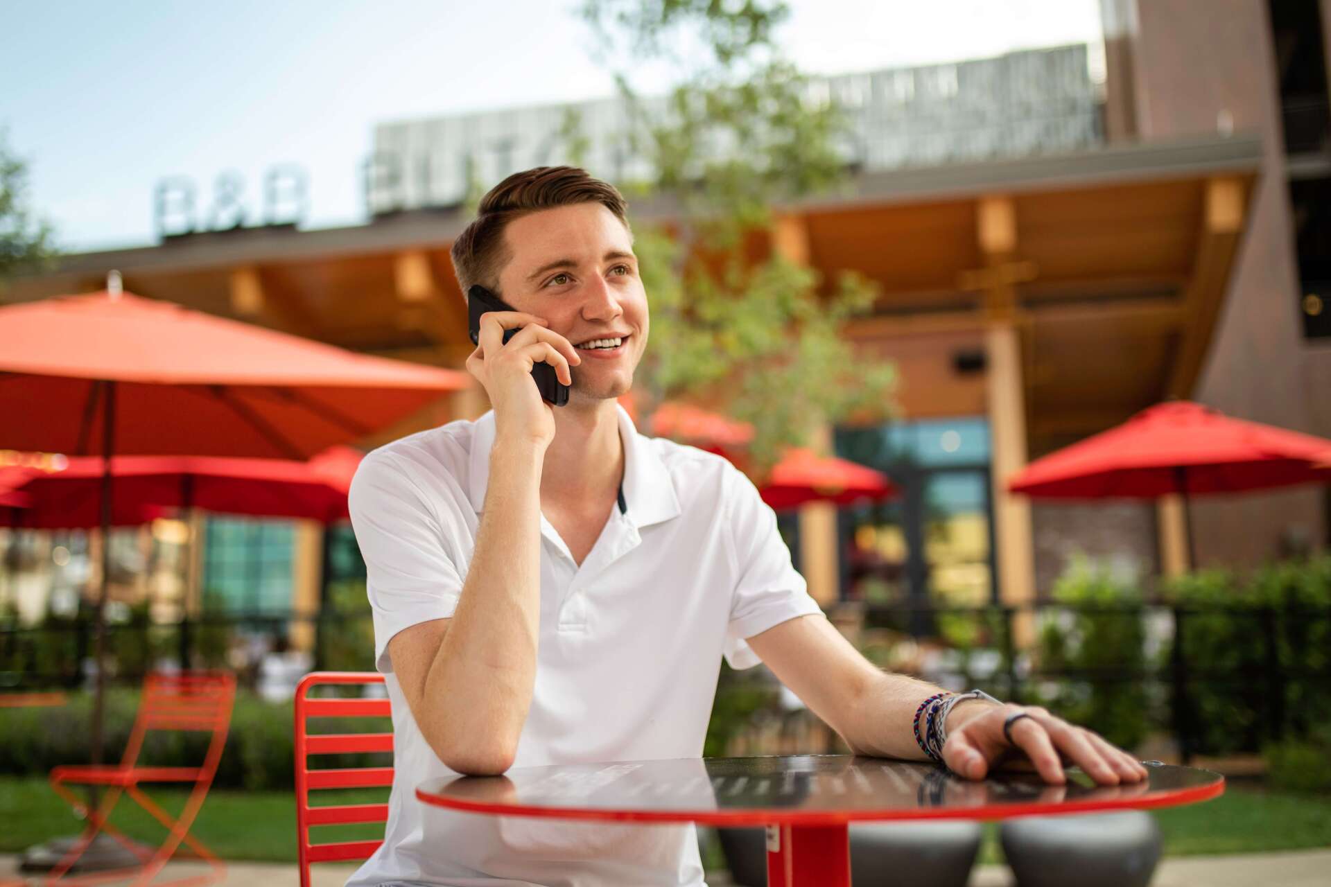 Man in White T-Shirt Sitting on Bench