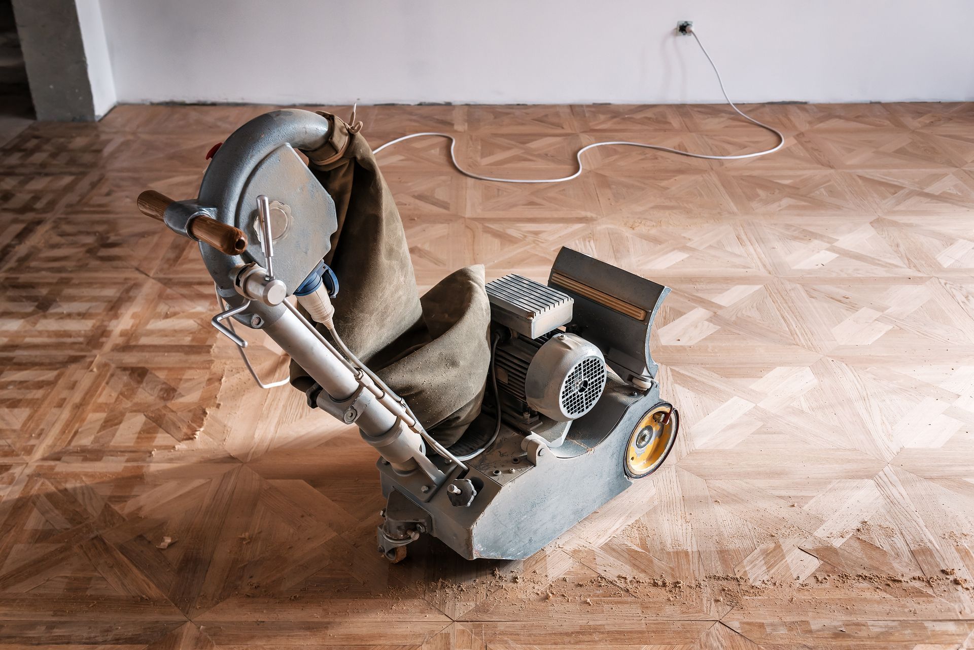 Picture of a wood floor sanding machine working on a floor.