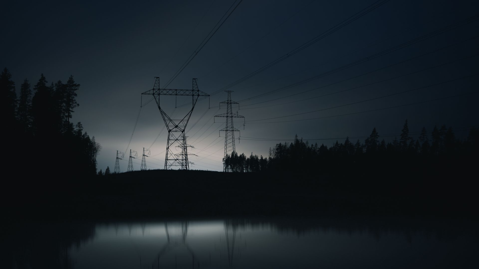Power lines in a darkened city during a blackout or brownout to reduce grid strain