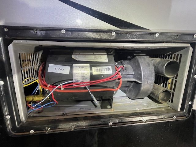 A close up of a motor with wires coming out of it.