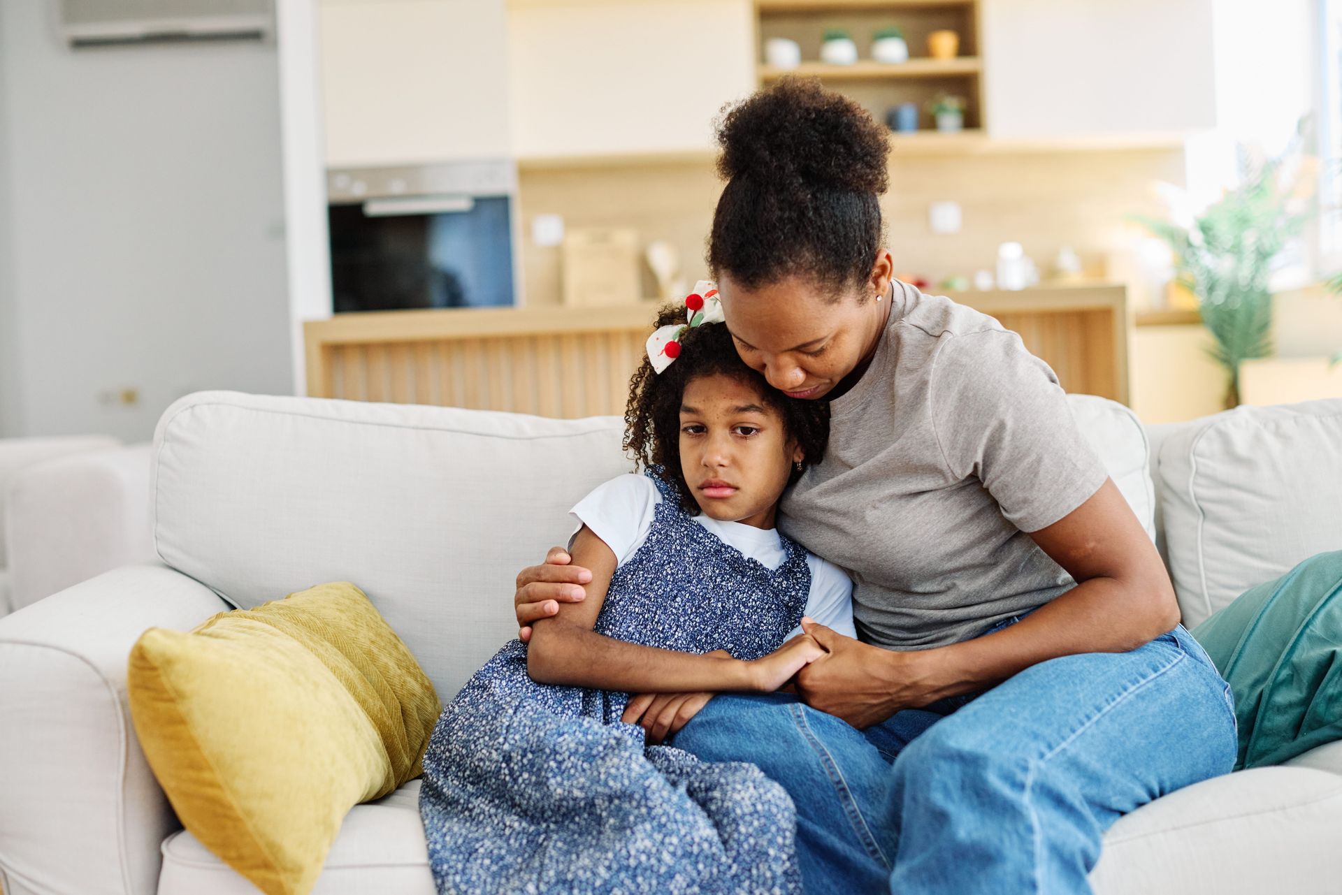 A man and a little girl are sitting on a couch.