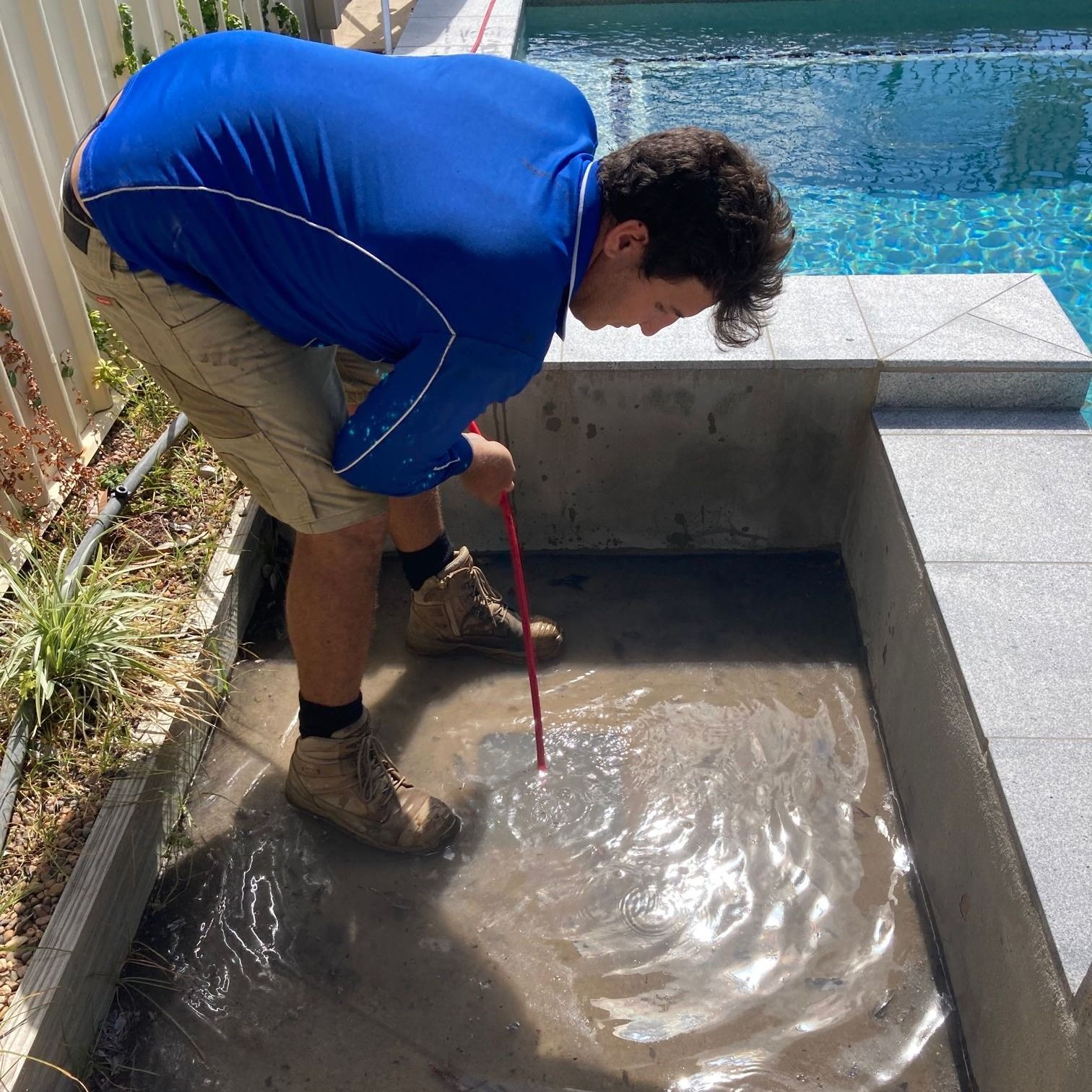 A skilled plumbing technician repairing a pipe in a home.