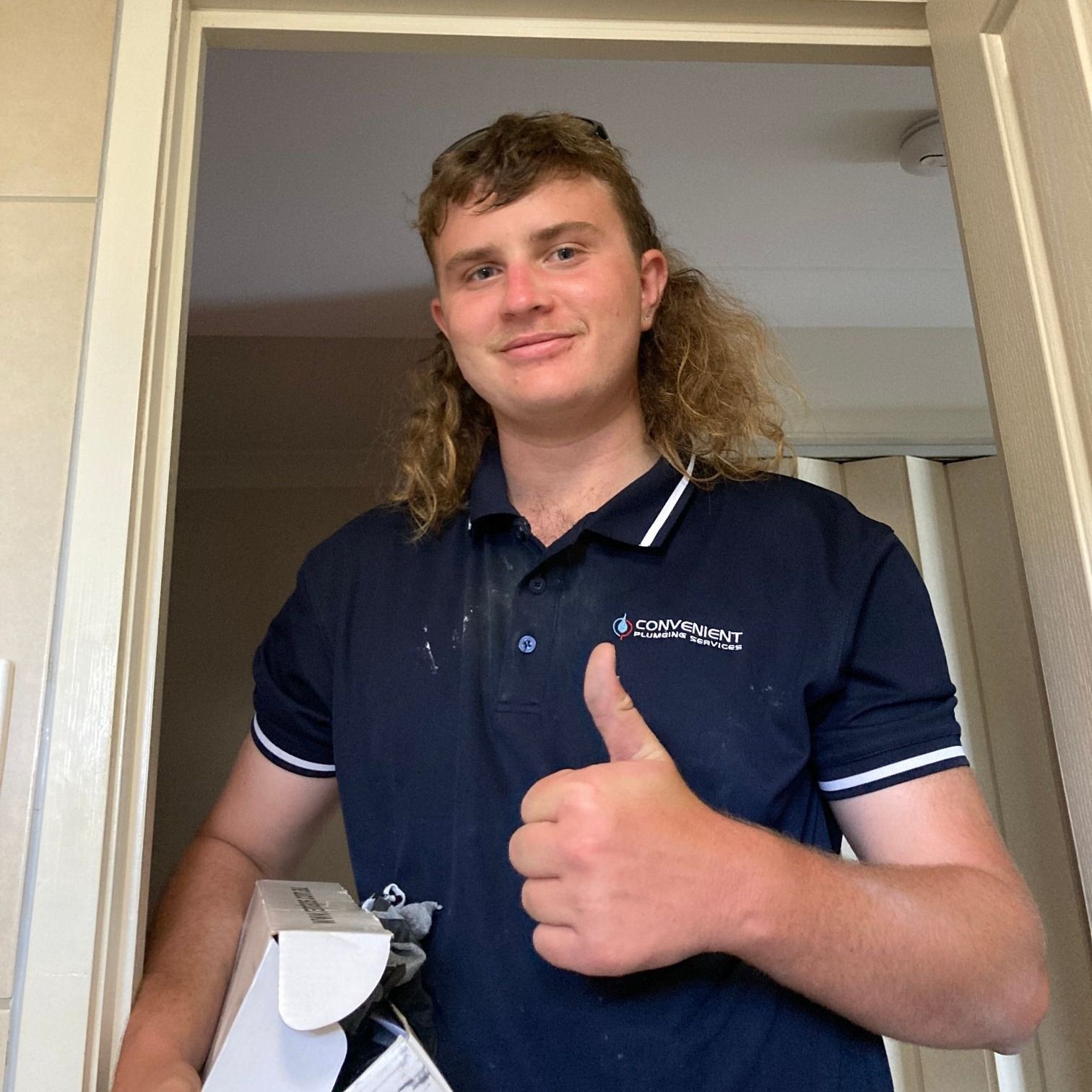 A professional team of plumbers solving plumbing issues on-site.