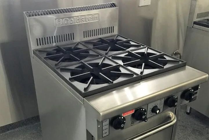 Commercial kitchen stove with six burners and stainless steel finish
