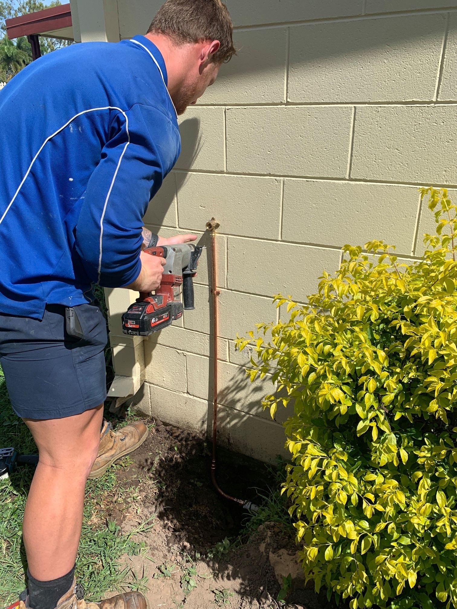 Plumbers collaborating on a job site to fix a plumbing issue.