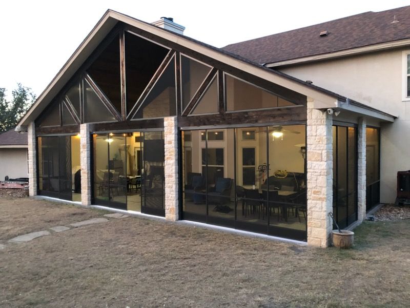A screened in porch with stairs leading up to it