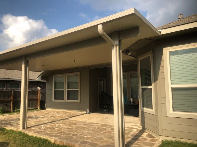 A house with a patio and a covered patio in front of it.