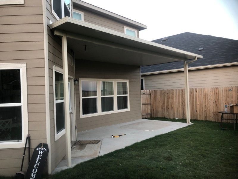 A house with a covered patio in the backyard