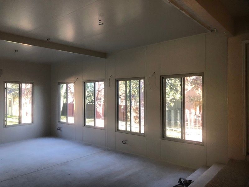 An empty room with a lot of windows and a ceiling