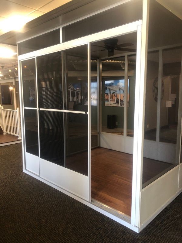 A room with sliding glass doors and a ceiling fan