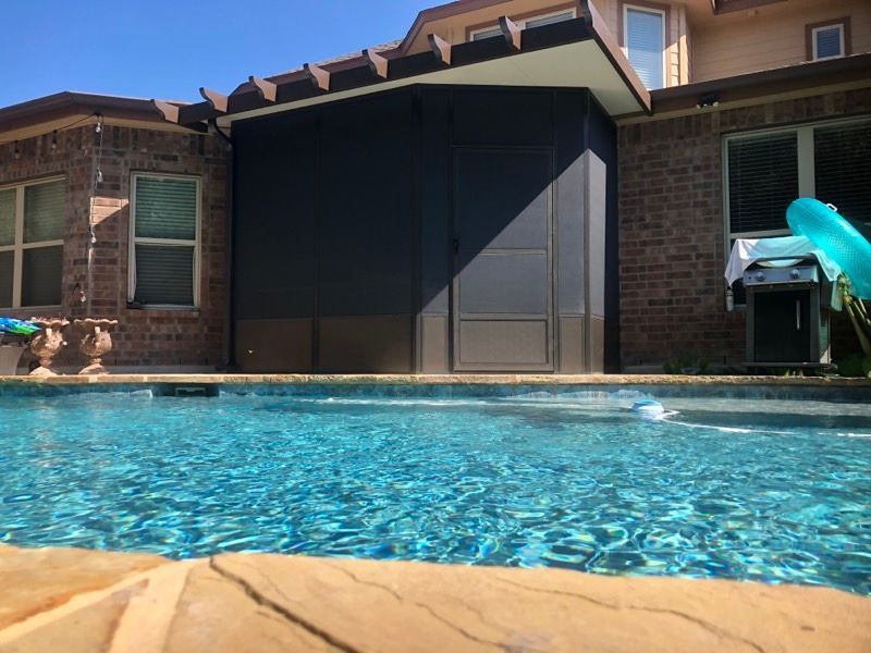 A large house with a swimming pool in front of it