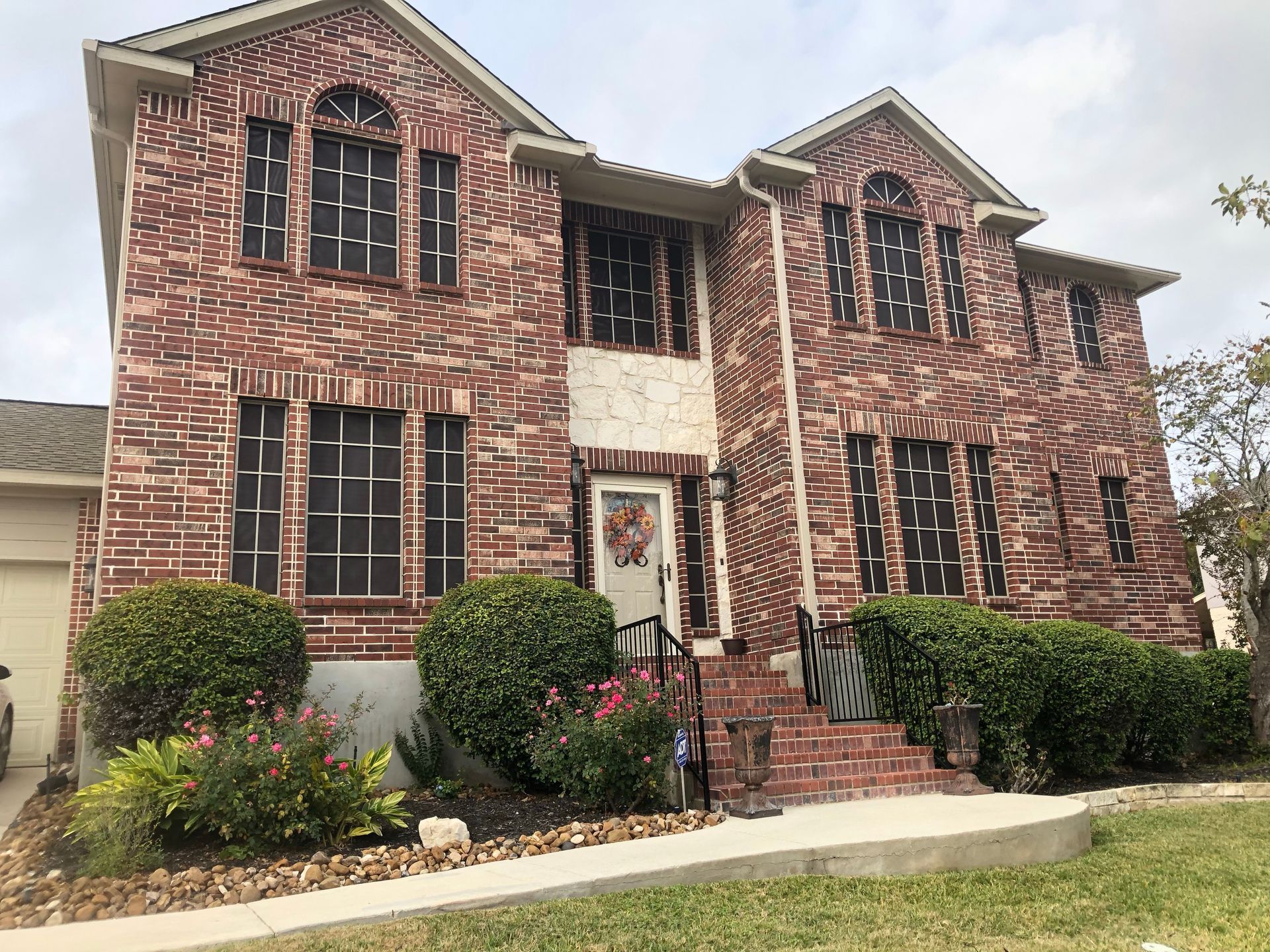 A large brick house with a wreath on the front door.