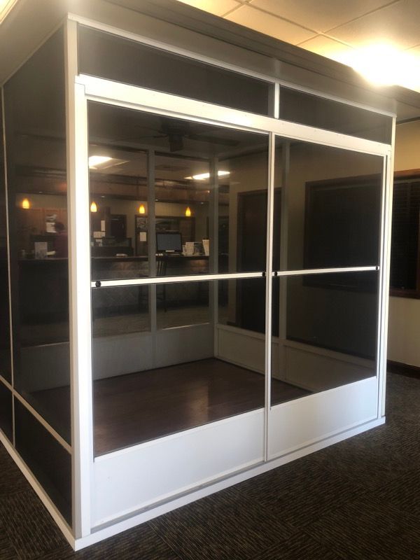 A room with sliding glass doors and a white frame