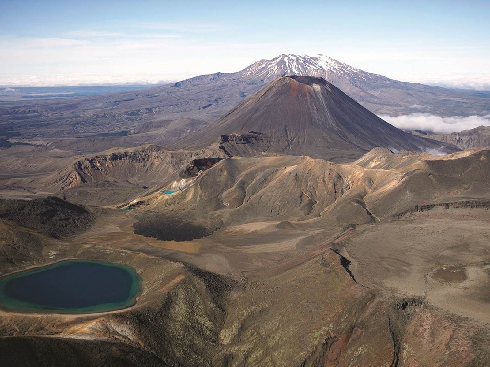 An aerial view of a volcano with a lake in the middle of it.