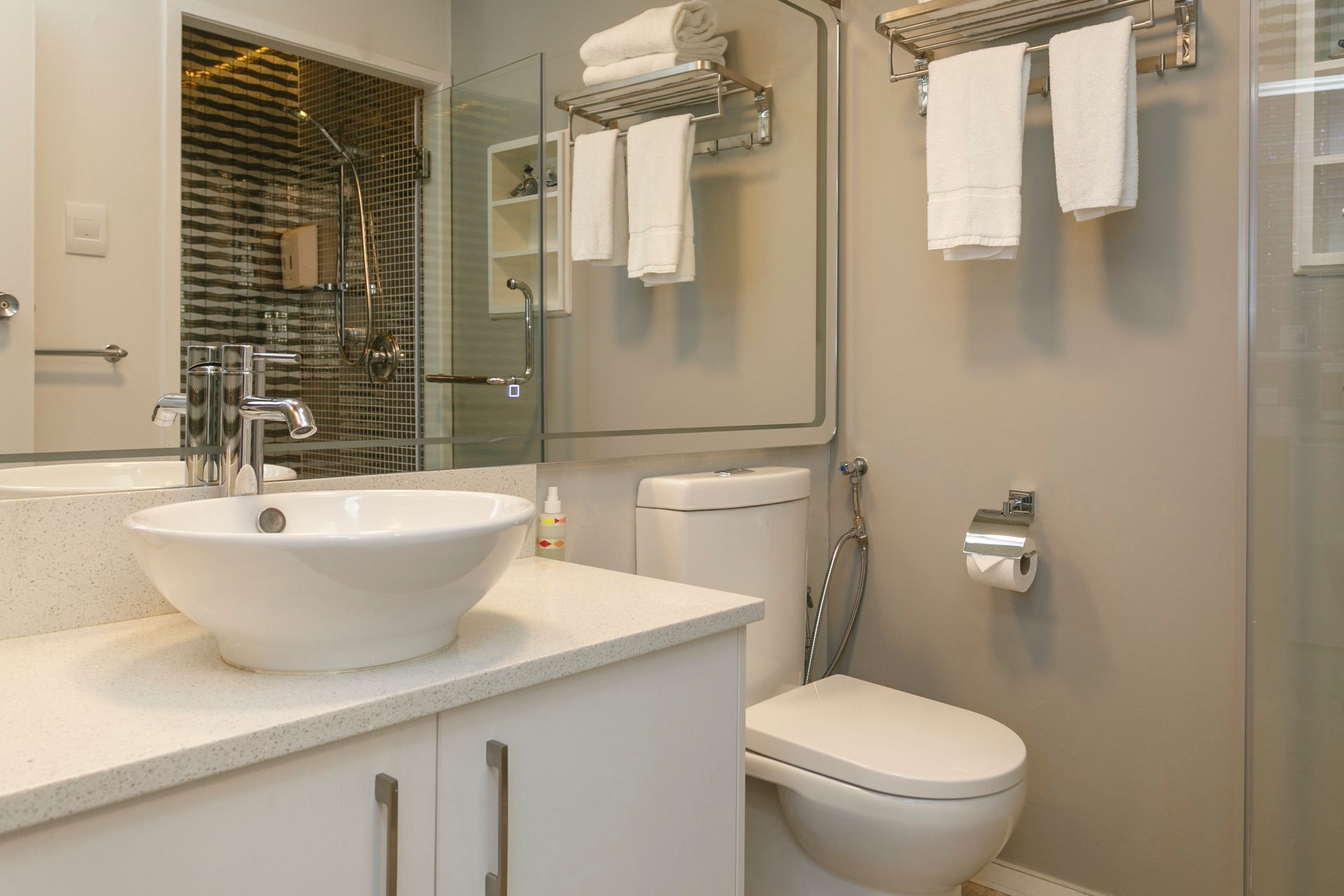 A bathroom with a sink , toilet and shower.