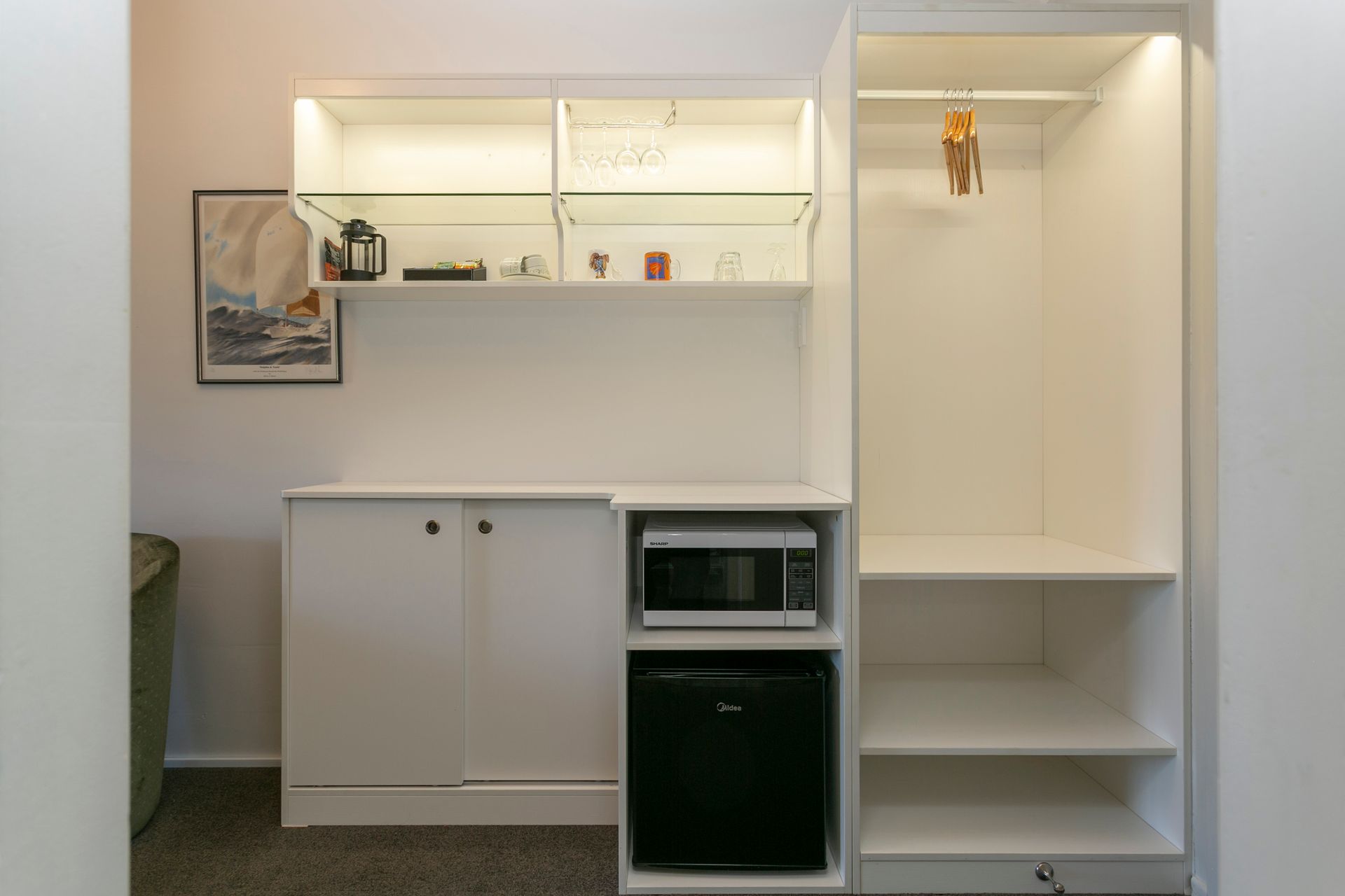 There is a microwave and a refrigerator in the closet.