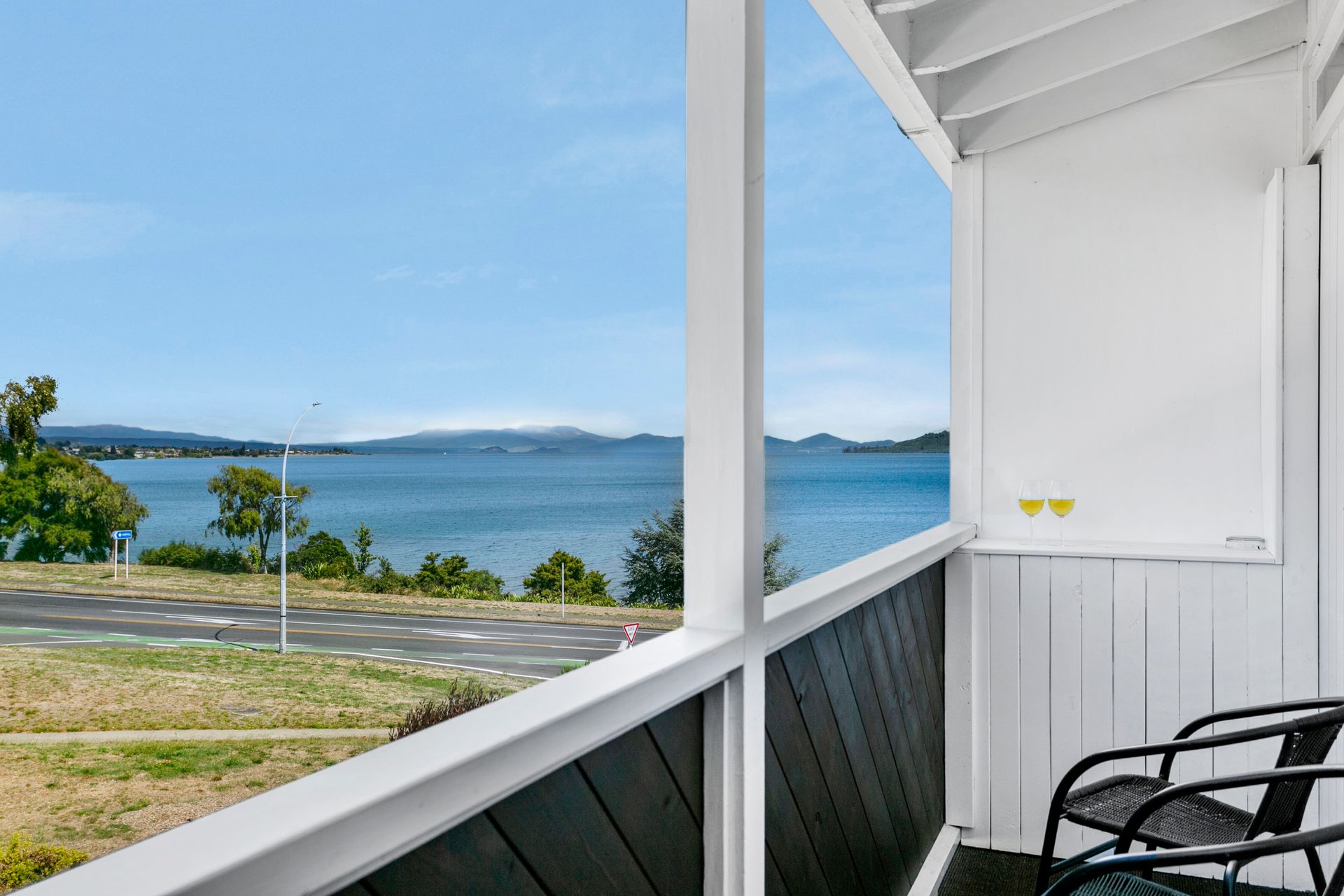A balcony with a view of a body of water