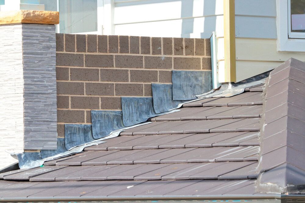 A Roof With a Chimney on the Side of It — Bradshaw Plumbing & Roofing Pty Ltd In Paget, QLD