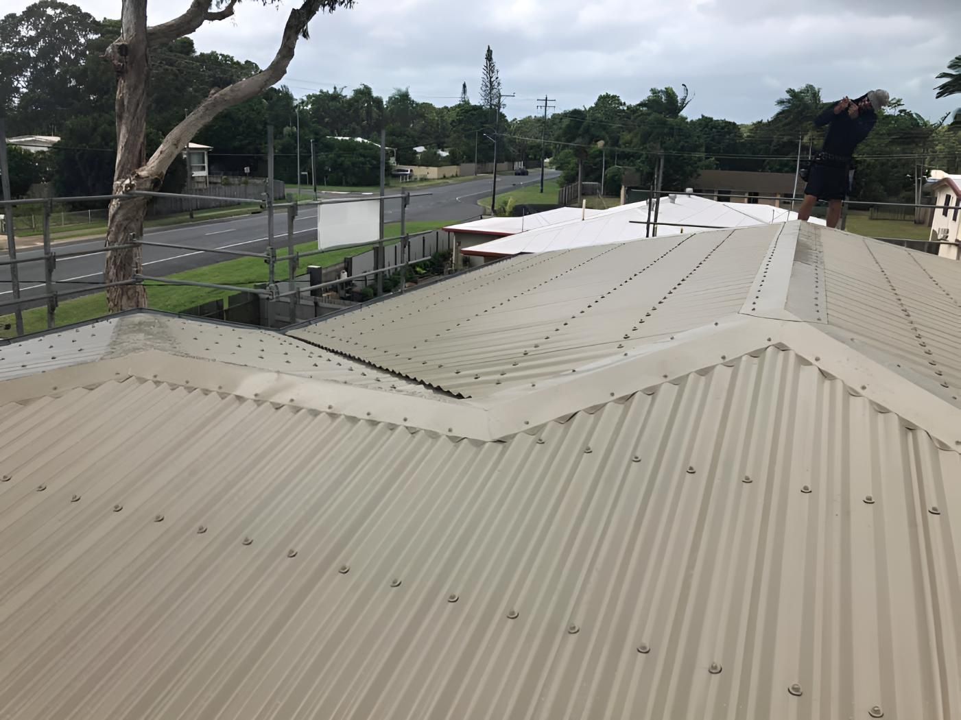 A Roof With a Tree in the Background and a Road in the Background — Bradshaw Plumbing & Roofing Pty Ltd In Rural View, QLD