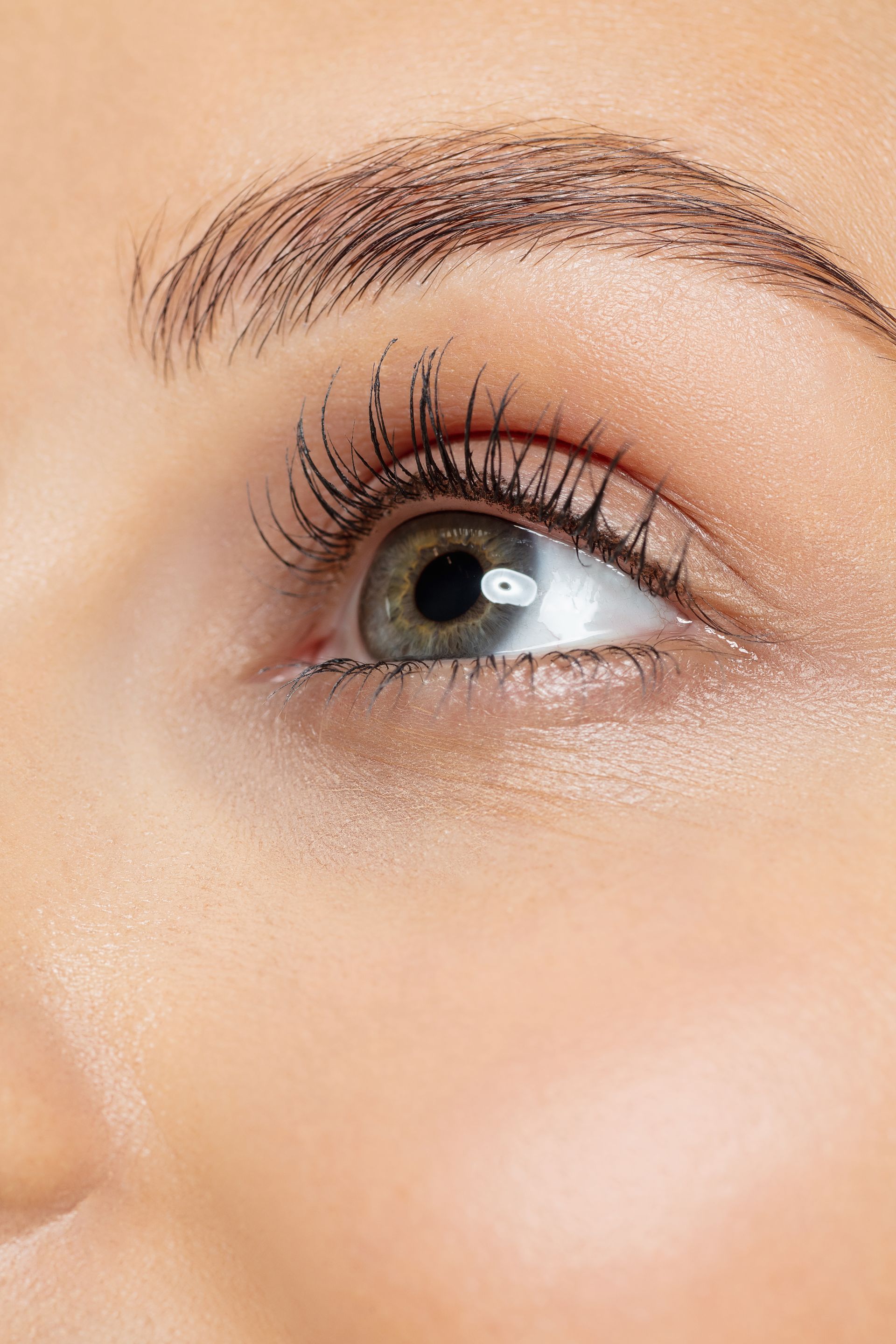 a close up of a woman 's eye with long eyelashes .