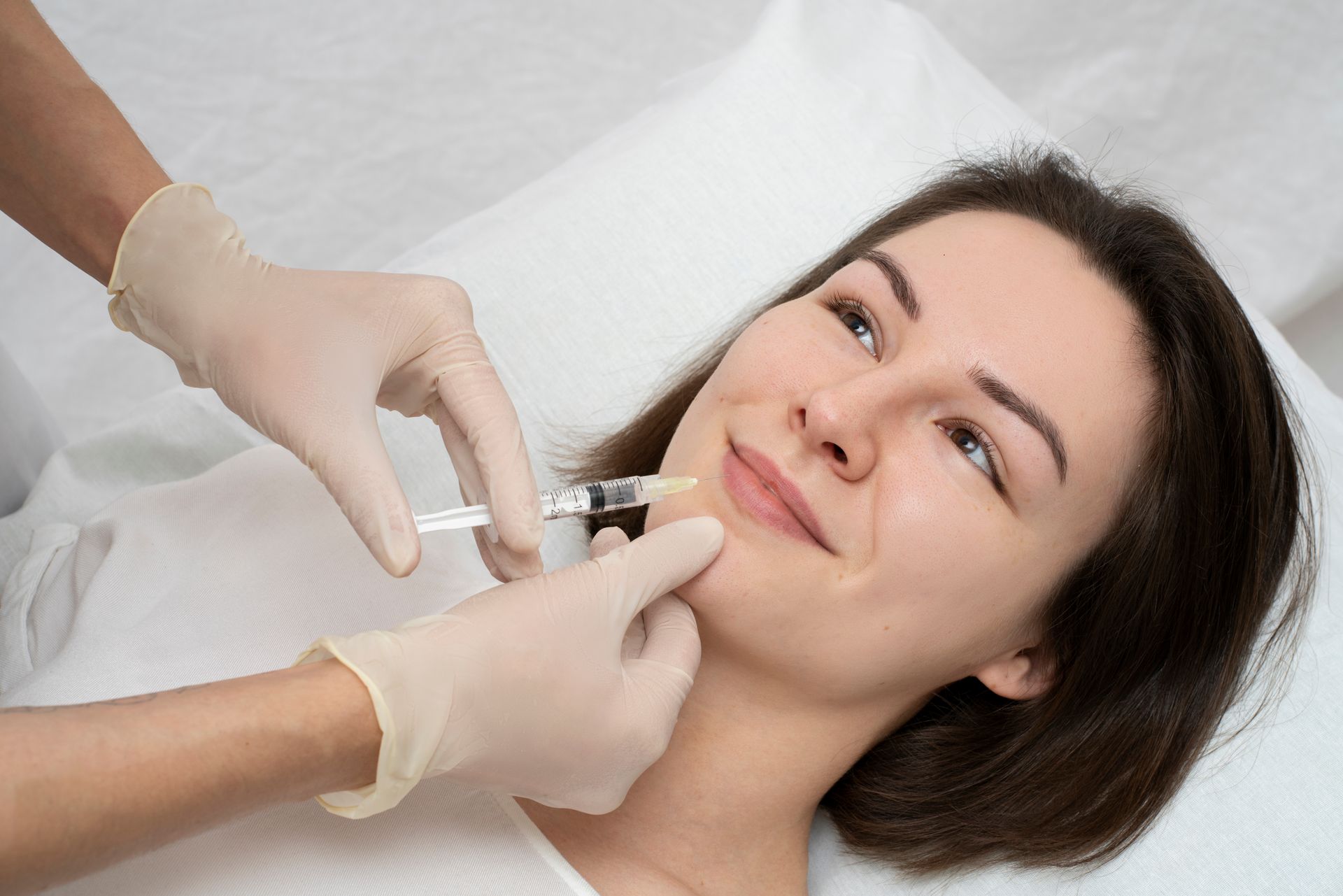 a woman is getting a botox injection in her face .