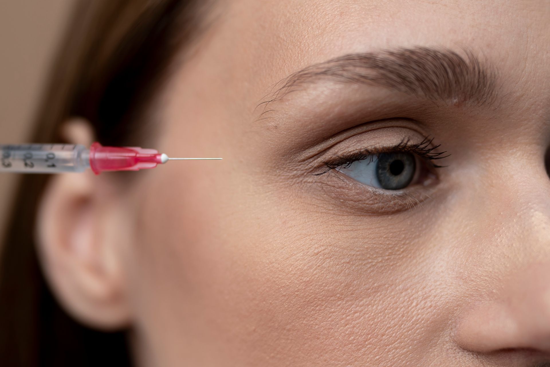 A woman is getting an injection in her eye.