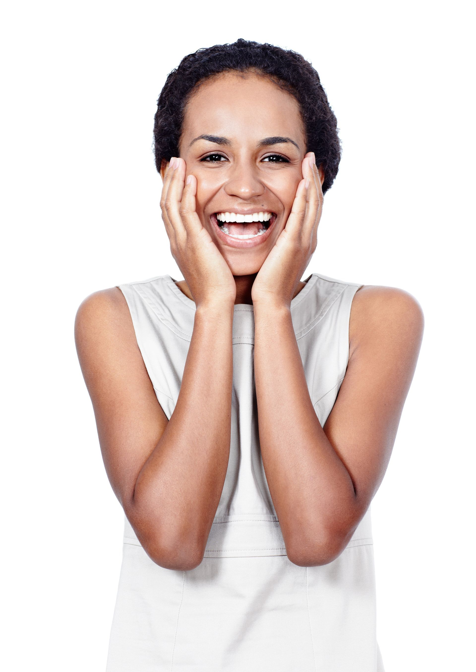 A woman is smiling with her hands on her face.