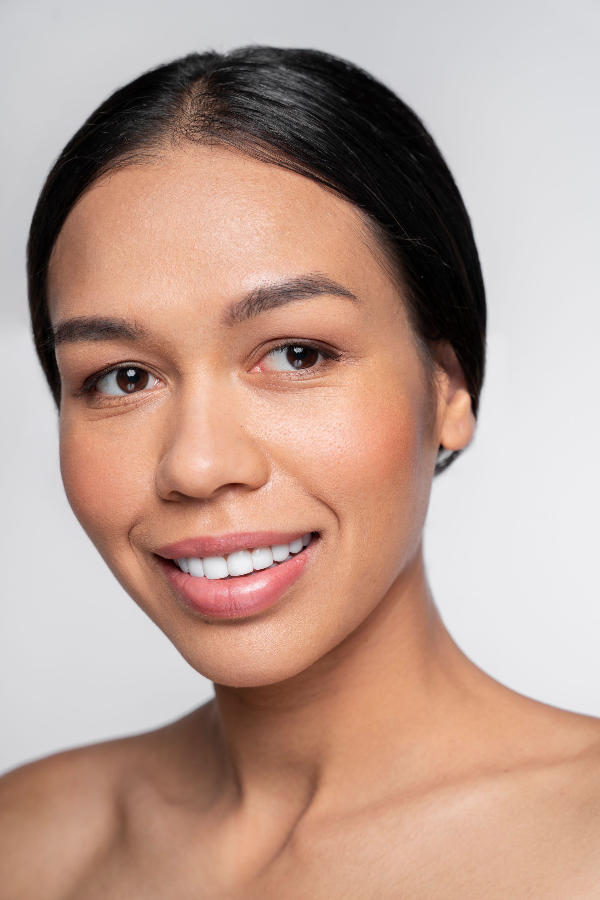 a close up of a woman 's face with a smile on her face .