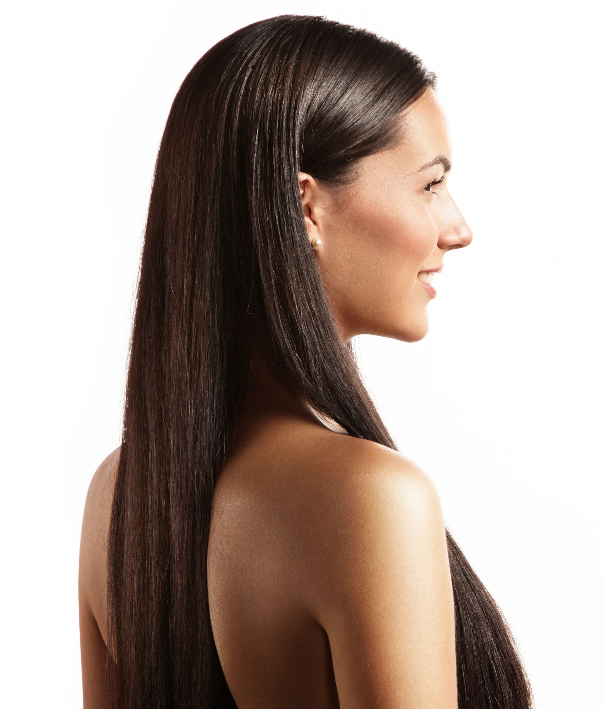 A woman with long hair is smiling and looking to the side