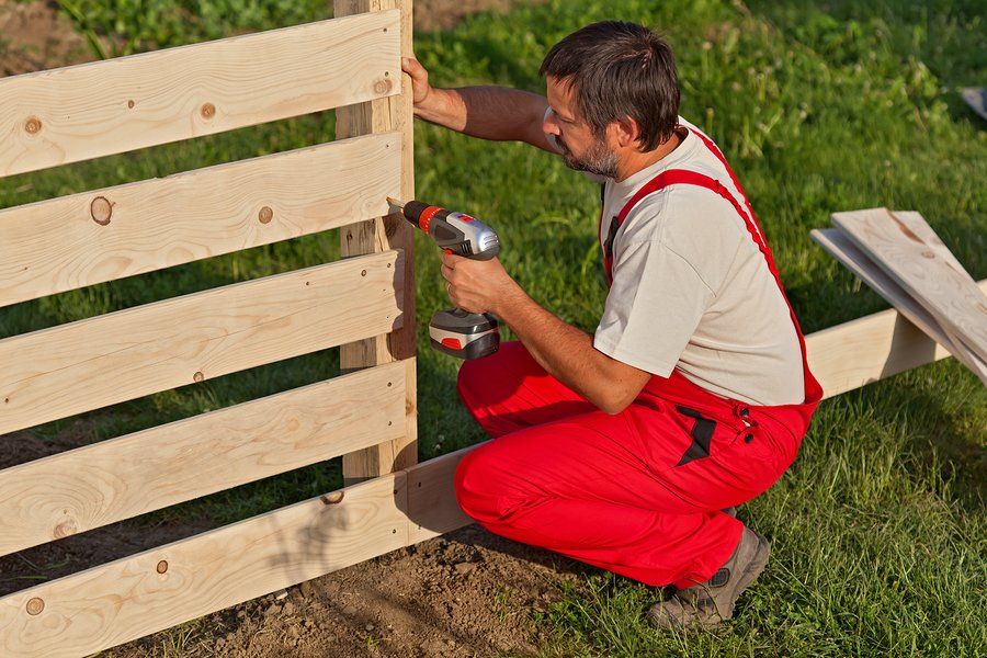man repairing fence in Mission Viejo