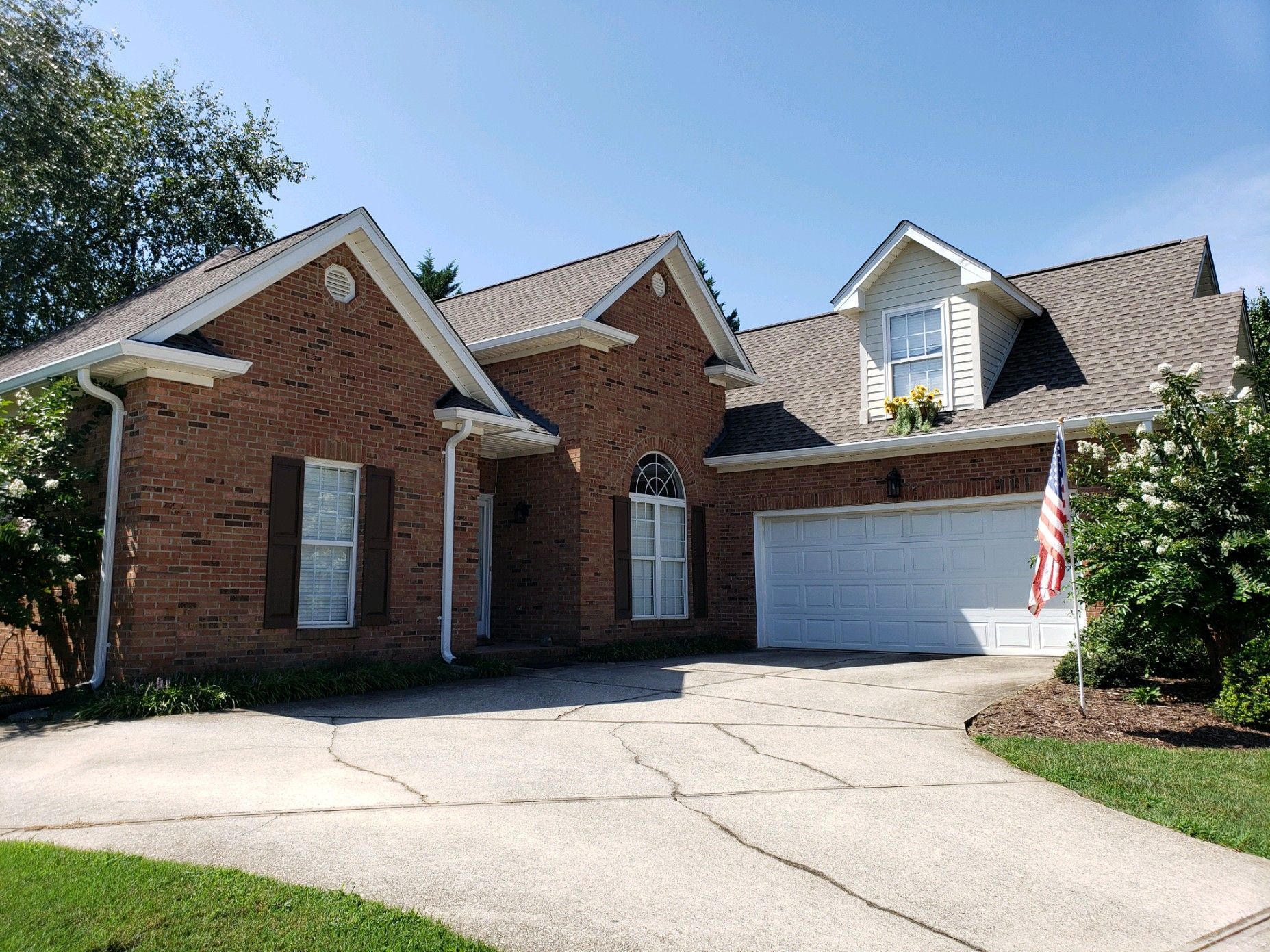 a large brick house with a white garage door