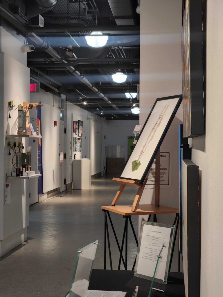 Modern office hallway with display boards and an easel on a table