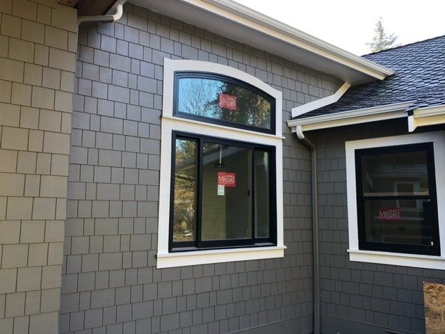 A house with a gray siding and black windows — Tukwila, WA — Bel-Red Windows & Doors