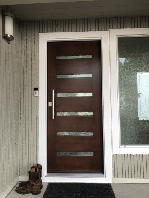A door with a dog statue in front of it— Tukwila, WA — Bel-Red Windows & Doors