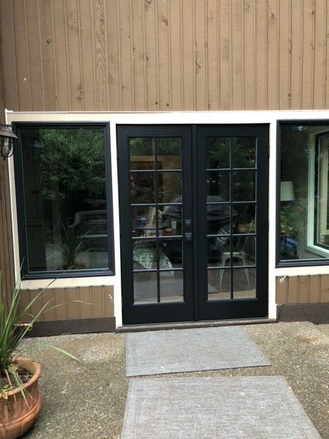A house with a black door and a lot of windows — Tukwila, WA — Bel-Red Windows & Doors
