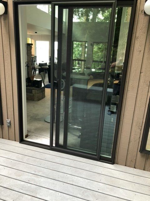 A sliding glass door is open to a living room — Tukwila, WA — Bel-Red Windows & Doors