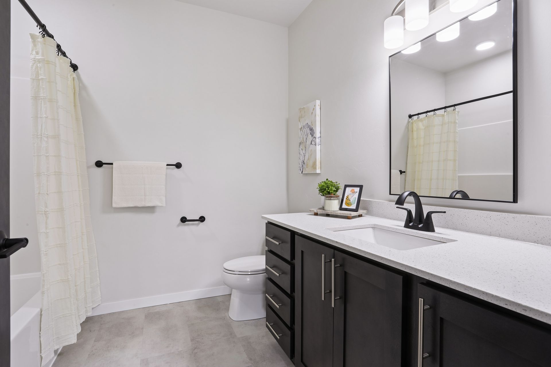 Modern bathroom with vanity, mirror, toilet, shower curtain, and white tile walls