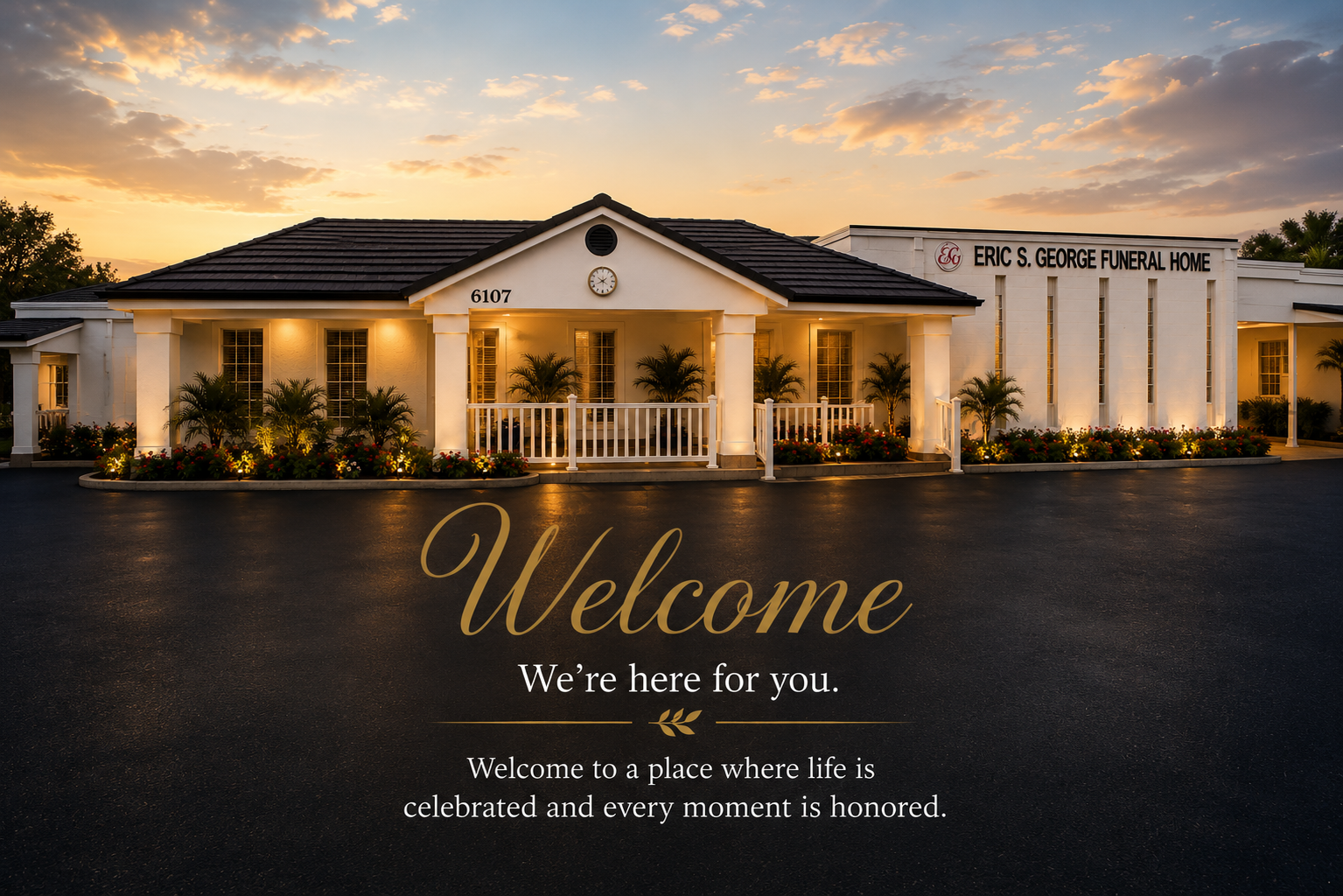 Elegant white event venue at sunset with a “Welcome” sign on the front lawn.