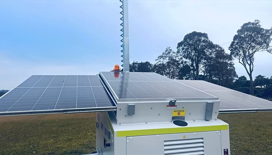 Mobile Solar Power Unit on a Grassy Field With a Tall Antenna — Hannant Plant Hire in New South Wales, AU