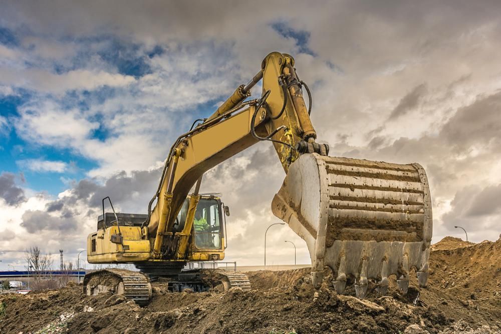 Yellow Excavator is Moving Dirt on a Construction Site — Hannant Plant Hire in Robina, QLD