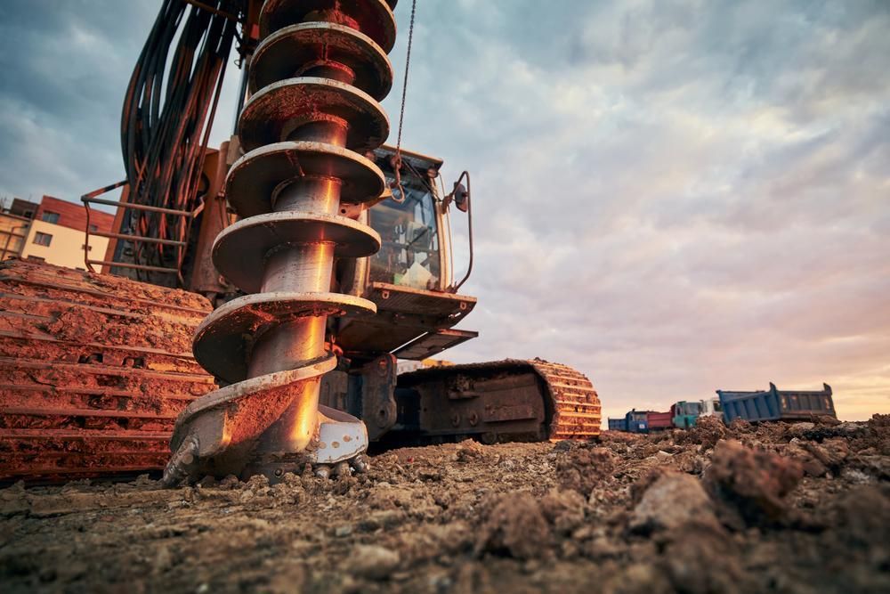 Bulldozer is Drilling a Hole in the Ground at a Construction Site — Hannant Plant Hire in Robina, QLD