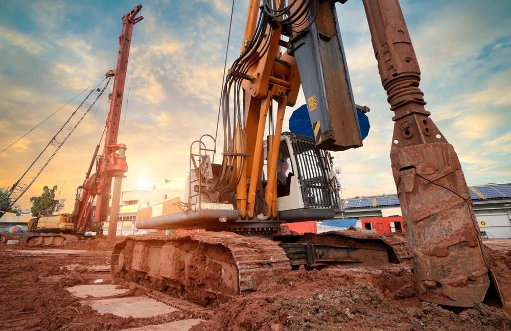 Large Excavator is Digging a Hole in the Ground at a Construction Site — Hannant Plant Hire in Perth, WA