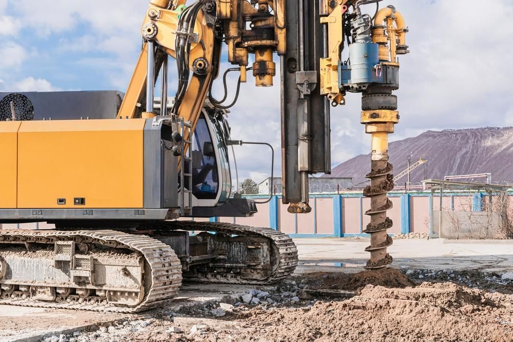 Bulldozer is Drilling a Hole in the Ground at a Construction Site — Hannant Plant Hire in Robina, QLD