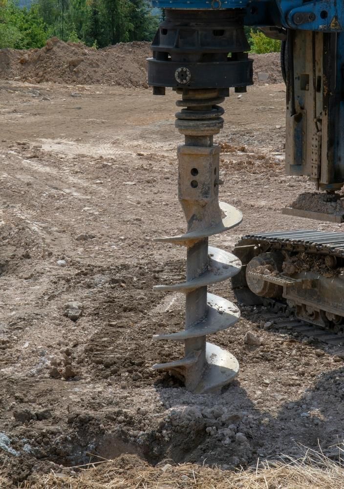 Machine is Drilling a Hole in the Ground on a Construction Site — Hannant Plant Hire in Robina, QLD