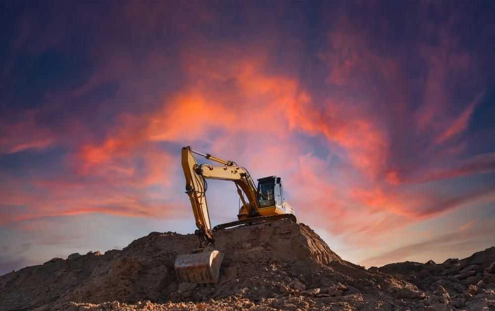 Yellow Excavator is Sitting on Top of a Pile of Dirt — Hannant Plant Hire in Perth, WA