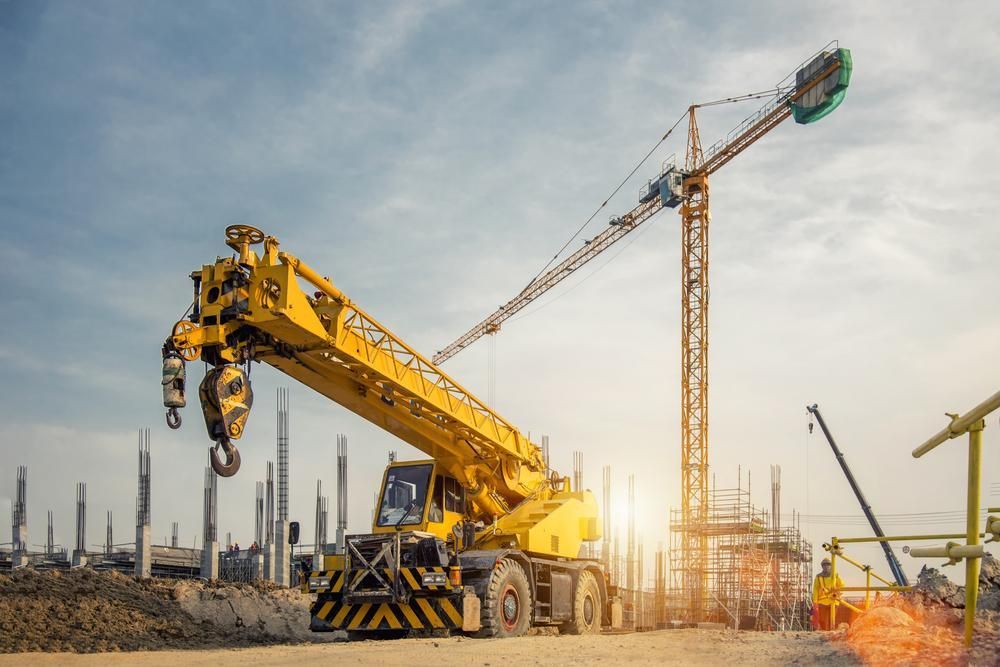 Yellow Crane is Sitting on Top of a Construction Site — Hannant Plant Hire in Robina, QLD