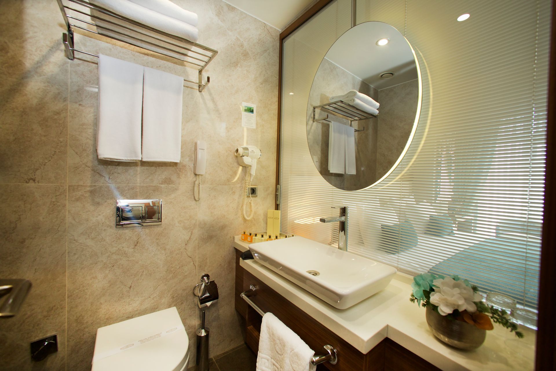 A bathroom with a toilet , sink and mirror