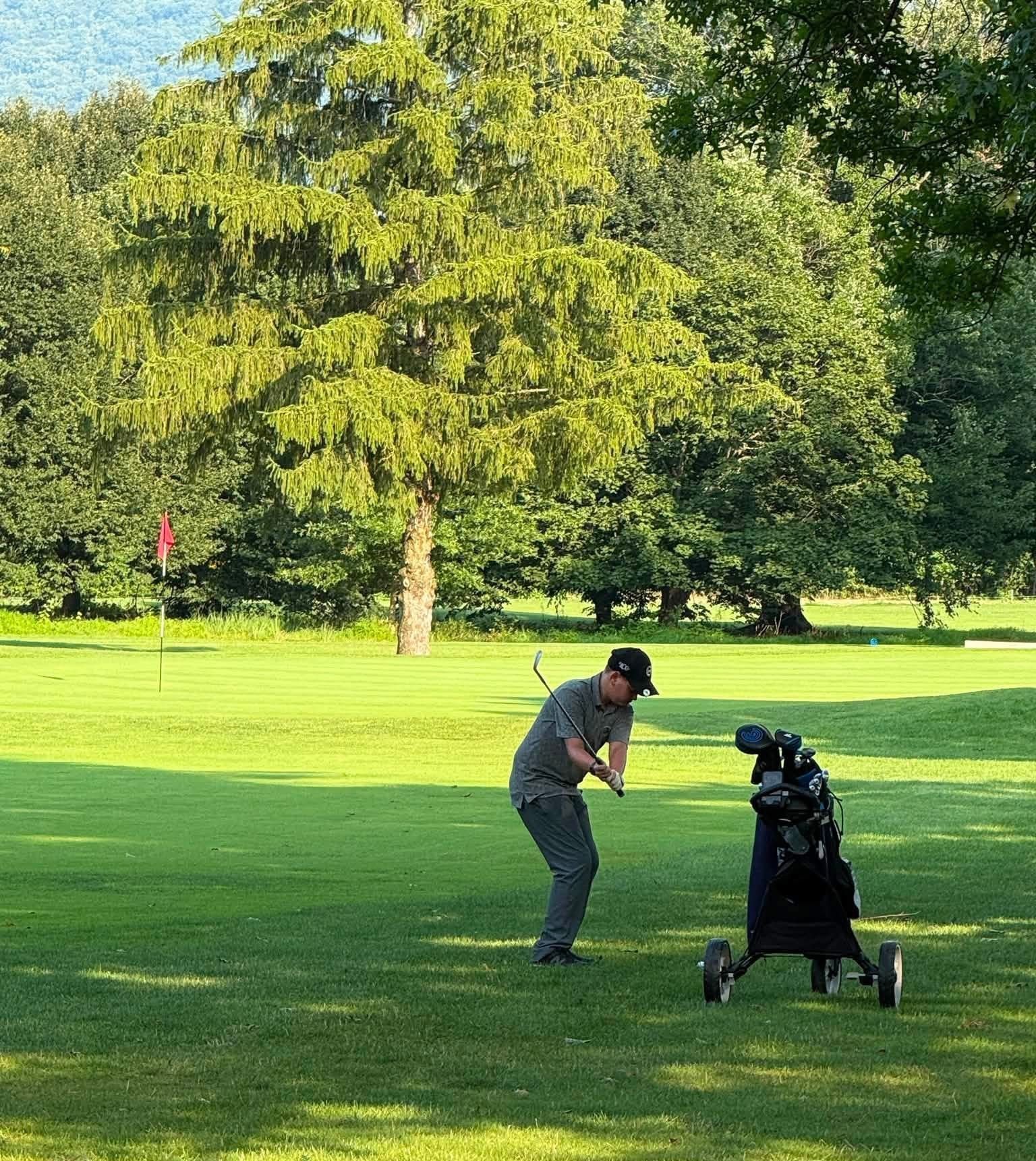 A group of people are playing golf on a golf course.