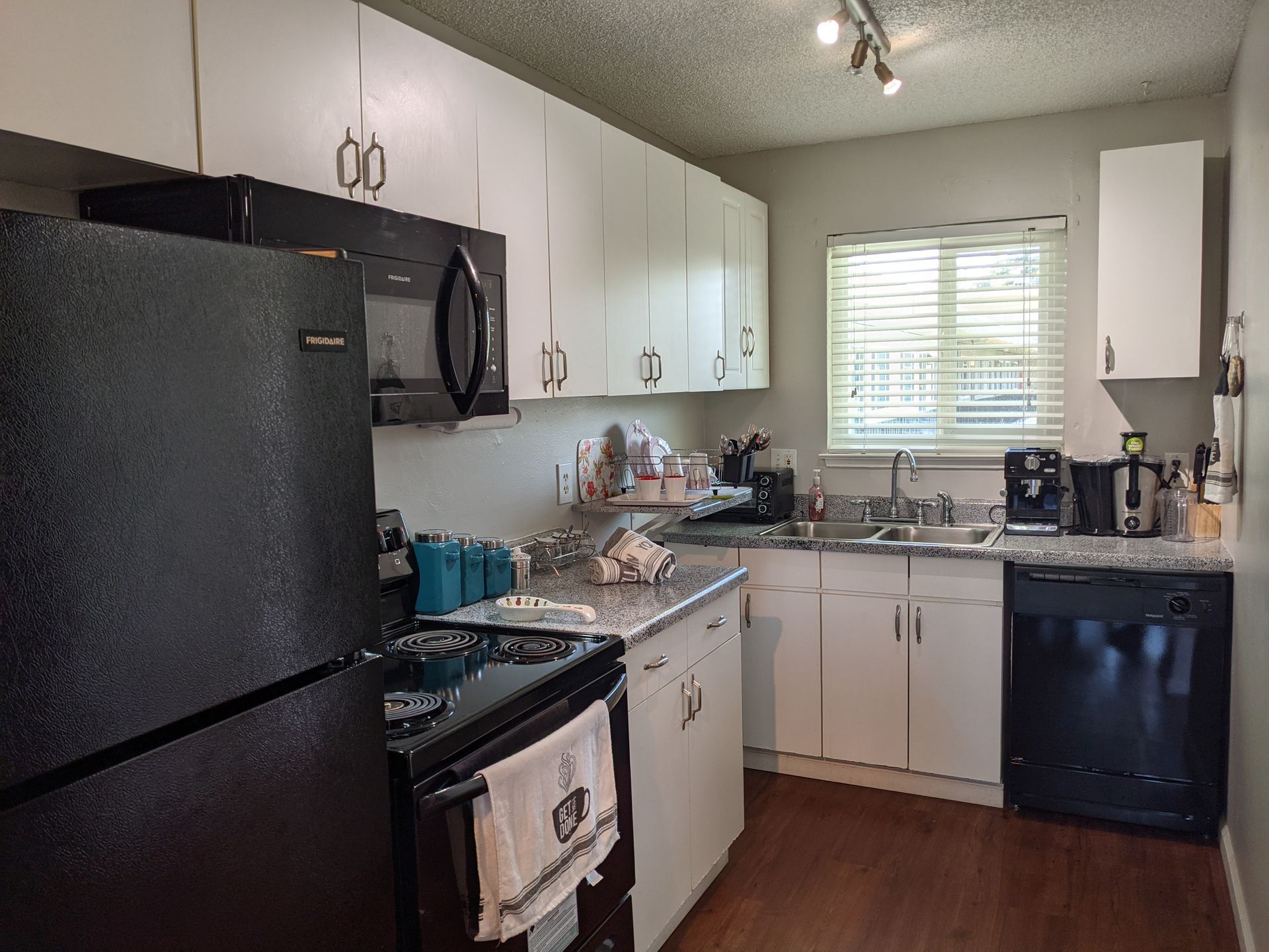 a kitchen with a frigidaire refrigerator and a microwave