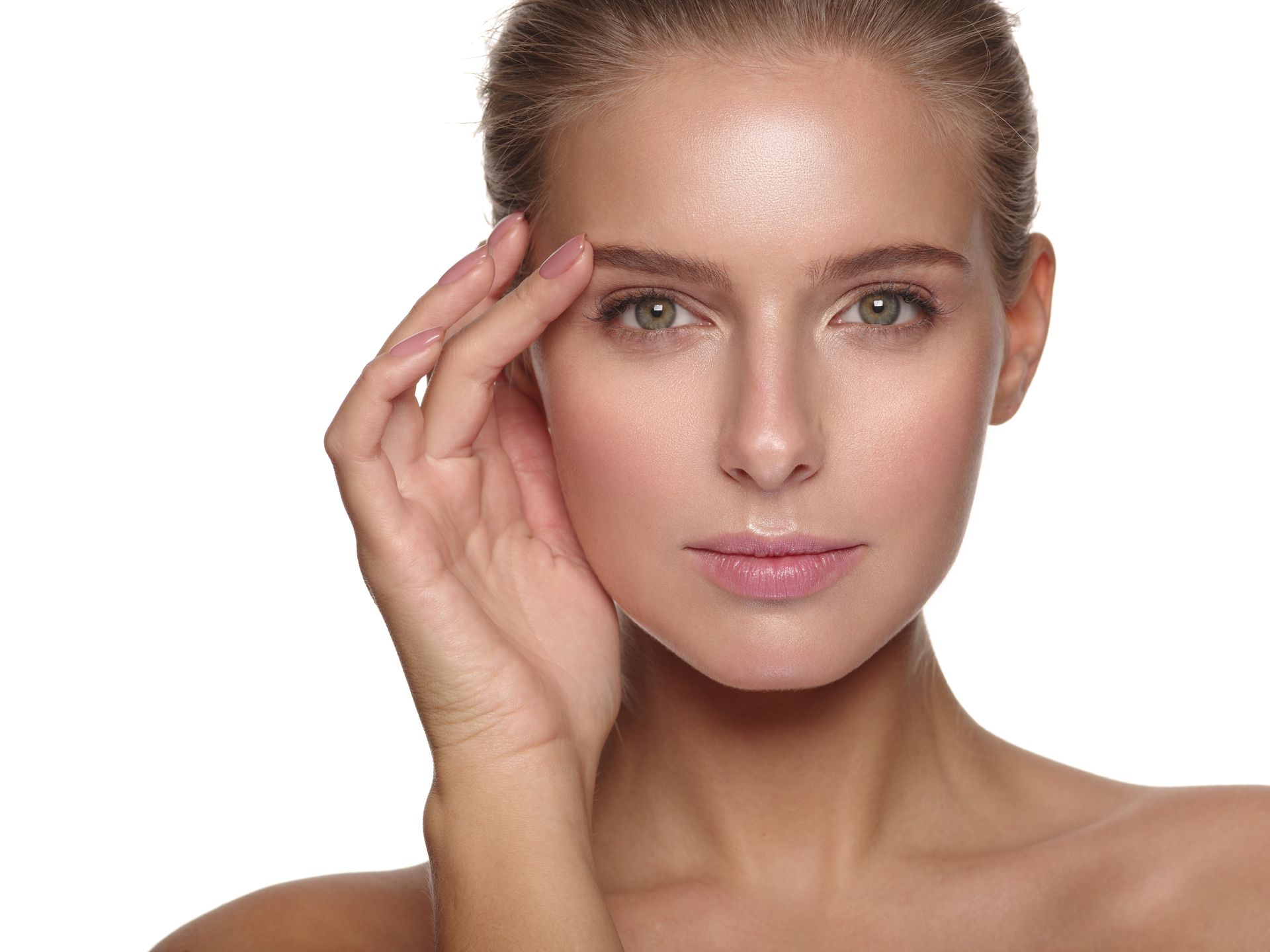 A person with glowing skin looking forward, gently touching their temple against a white background.